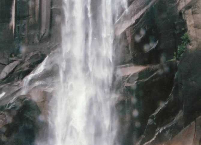 A waterfall crashing over a mountain cliff and landing in rocks below
