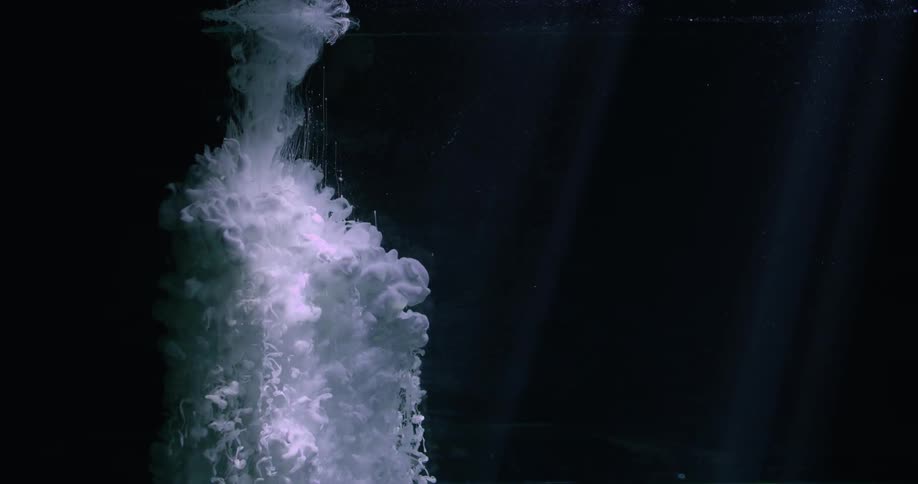 White liquid is poured into a black background