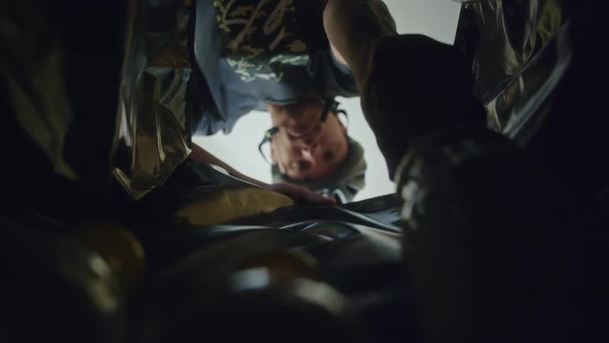 A man puts bottles in a bag
