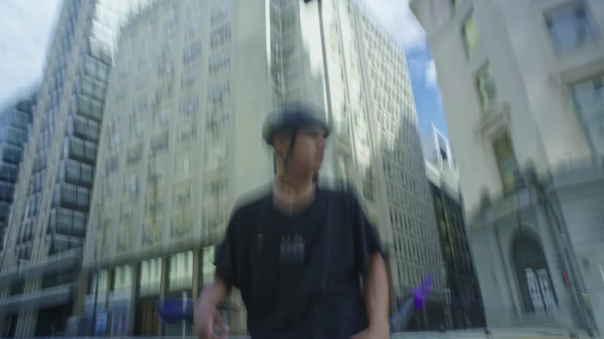 A man is standing in the city with his bicycle