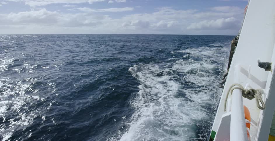 Waves move in the water as the boat passes