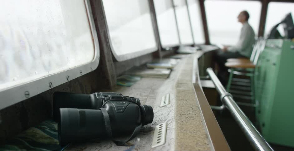Binoculars sitting on a ship's control deck