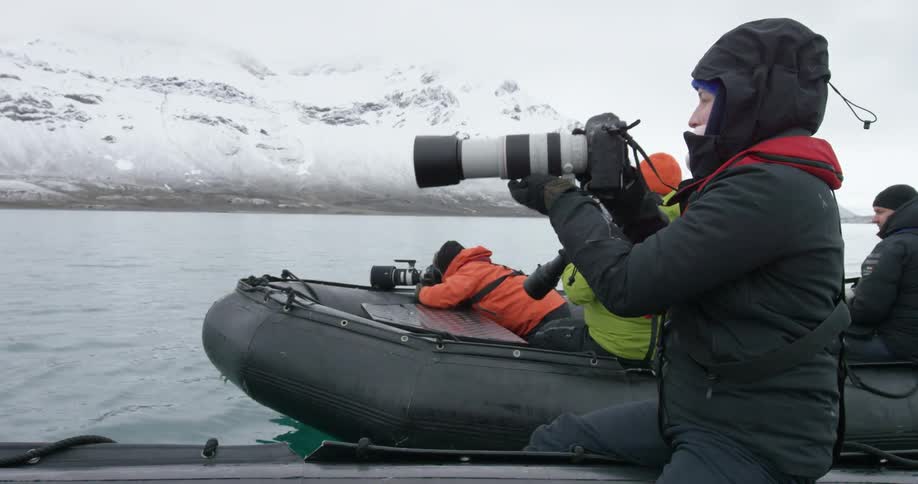 People are taking photographs from two rafts