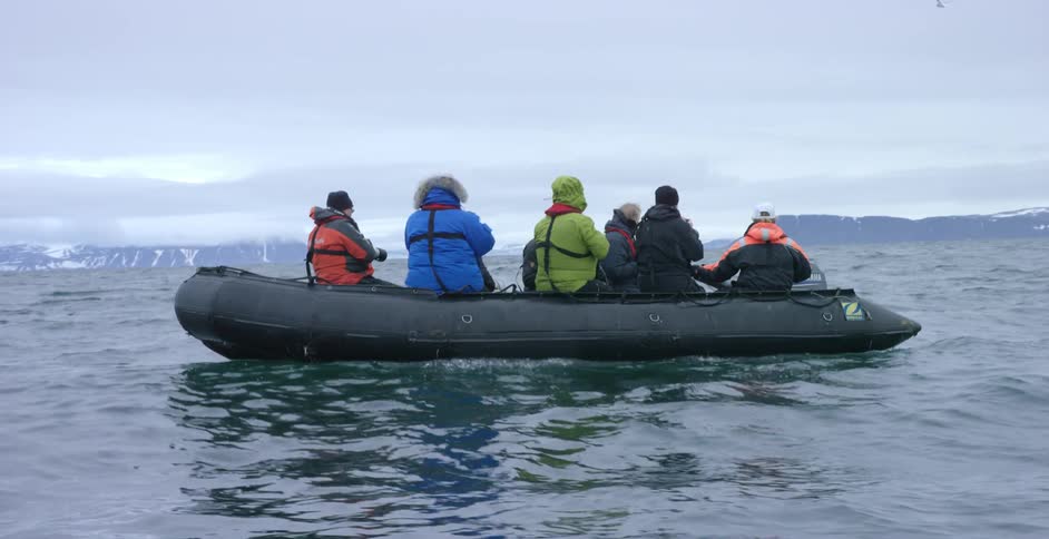 Several people floating on a big raft in the middle of the sea