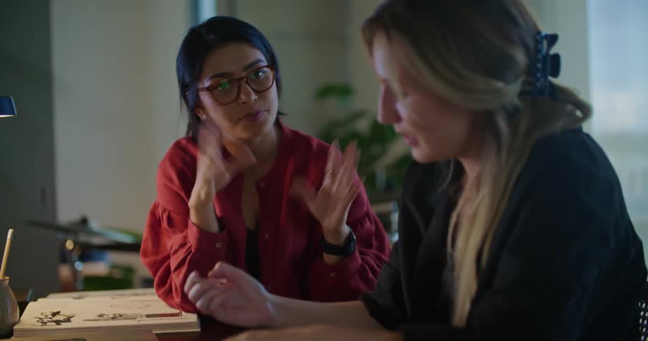 Women hold discussion in office and make notes