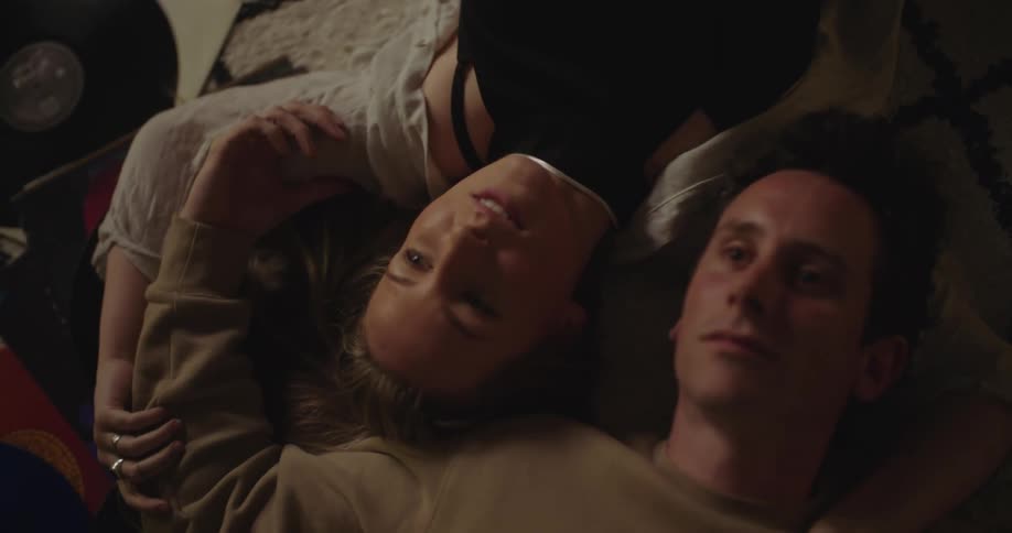 A man and woman laying around talking