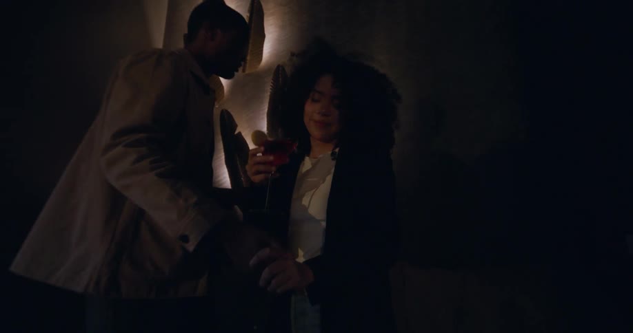 Man and woman hanging out dancing cocktails at a night club
