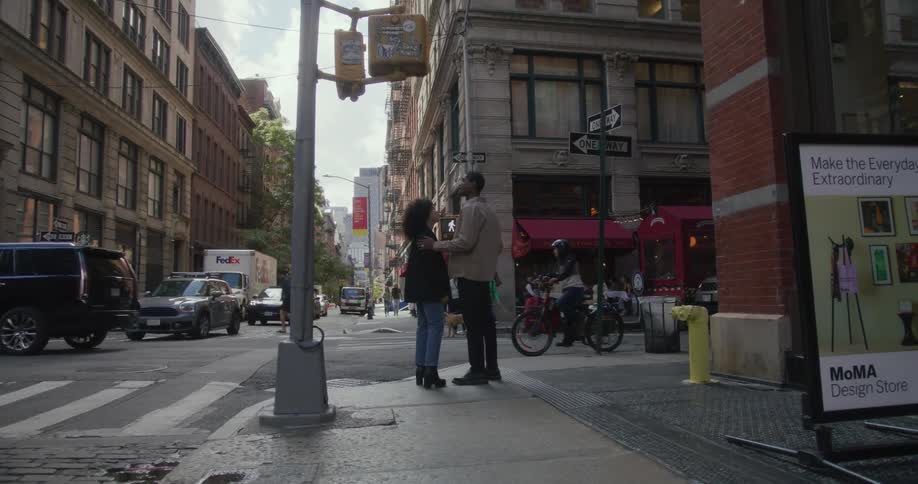 Young man and woman romantic couple standing on street corner downtown los angeles affectionate