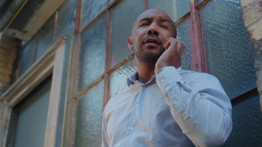 The view is of a man talking on the phone outdoors