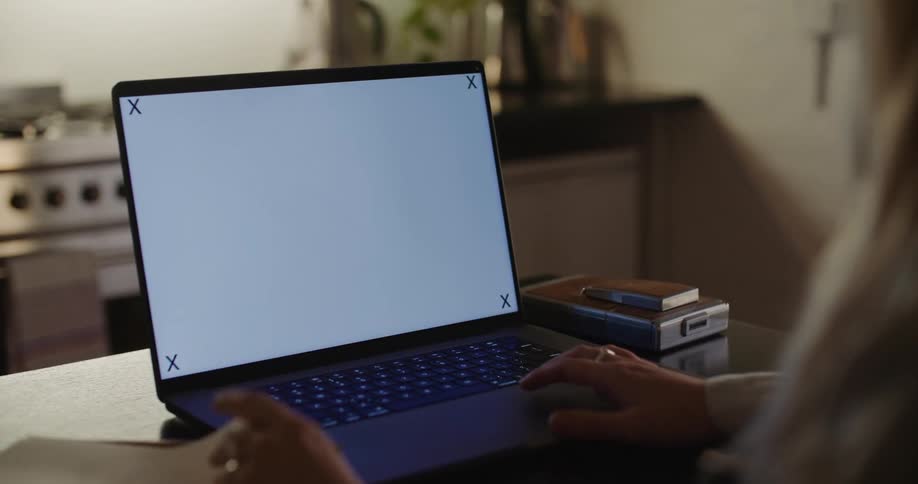 Close up of the replaceable screen on a laptop over a desk in the kitchen at home