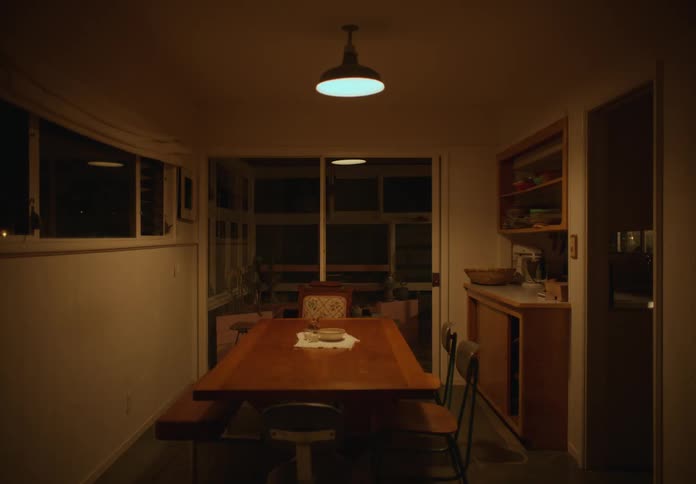 An empty home dining room with a wooden table with a bench and chairs