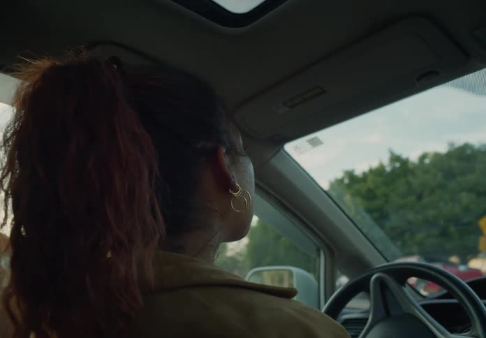 A woman is driving a car