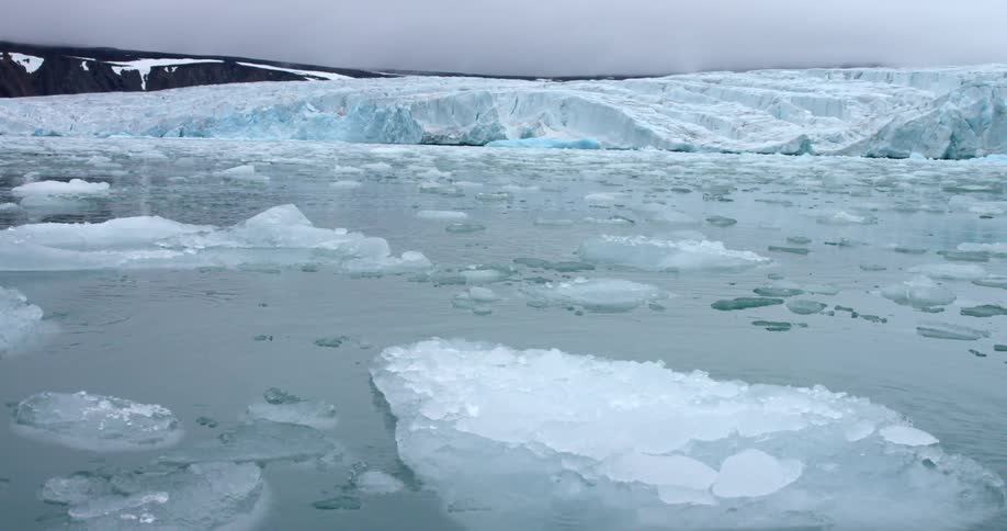 Ice floes float on the ocean near a glacier