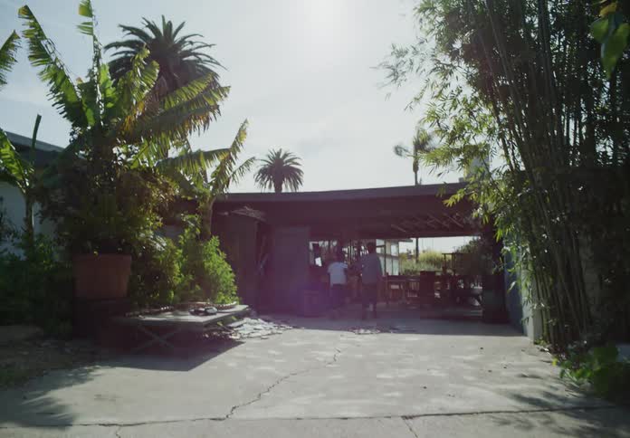 Tween brothers running down driveway towards the house to go inside