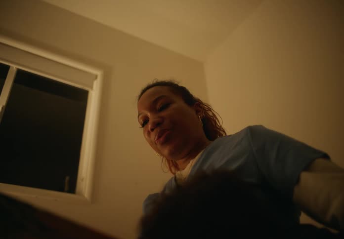 A woman reads a bedtime story to a boy under a window