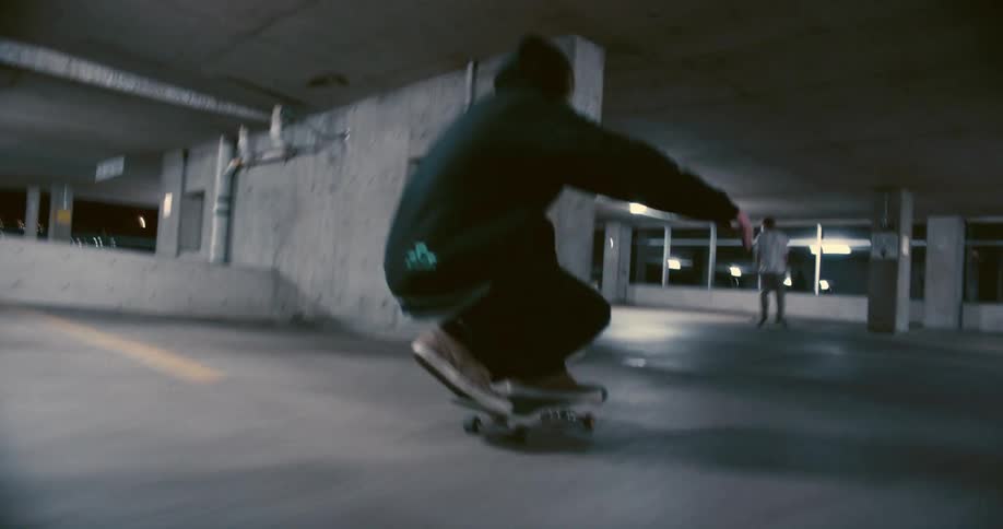 People are skateboarding in the parking lot