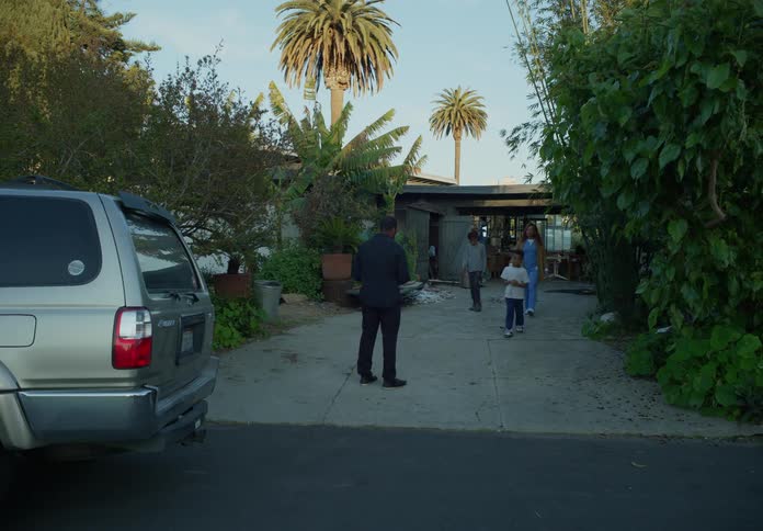 Father coming home early in the morning is greeted by his wife and kids