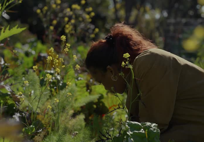 A woman is outdoors in her garden during spring
