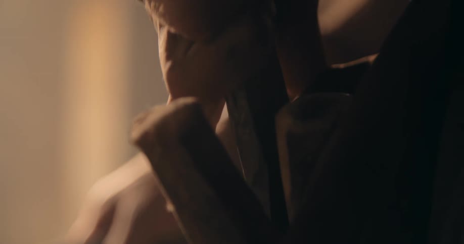 A close up ofa persons hand reaching into a pocket and pulling out a tool