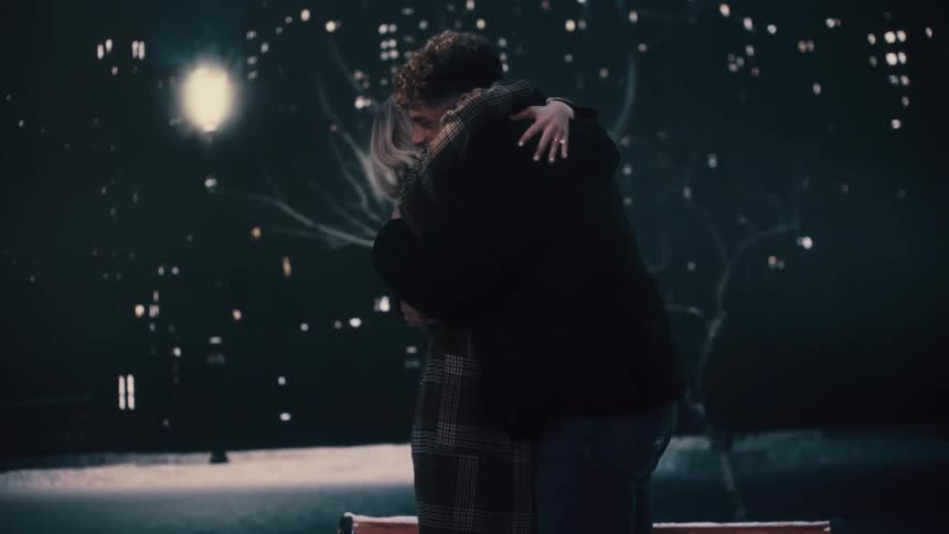 A man and woman getting engaged smiling and hugging each other