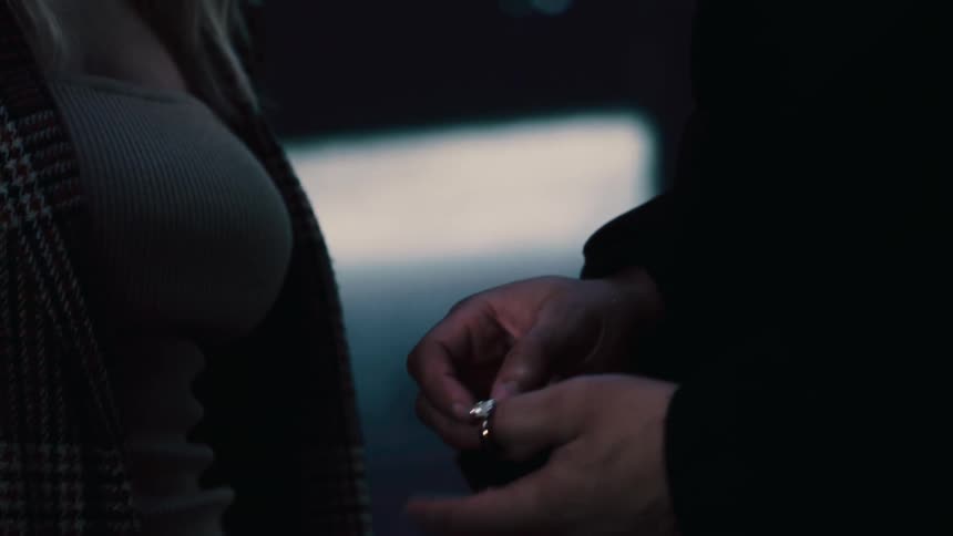 A man proposes to a woman and gives her a diamond ring