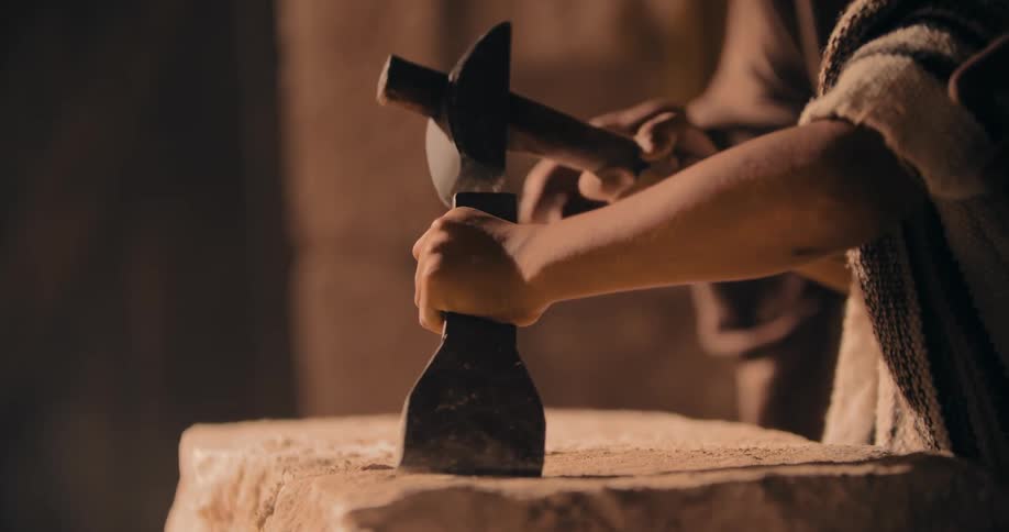 A person is carving stone