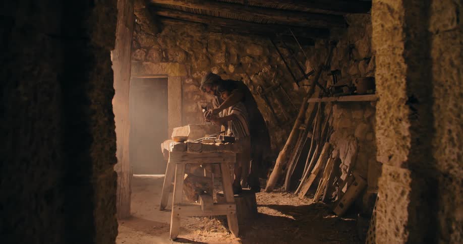 Father and daughter working together in wood workshop during the day