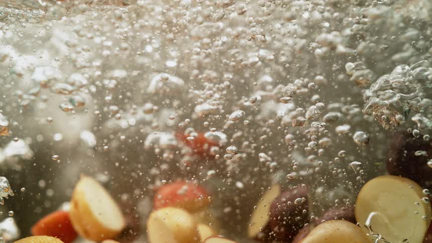 Potatoes are boiling in the water