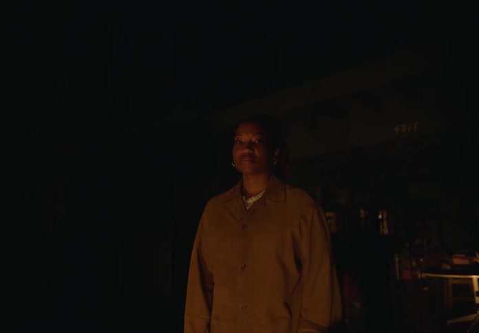 A woman is standing in the dark