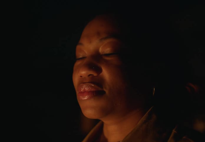A portrait of a woman outdoors at night