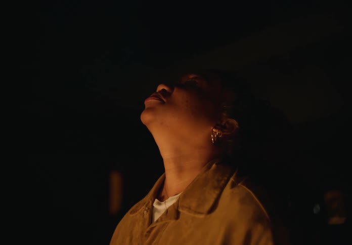A woman looks up and to the side