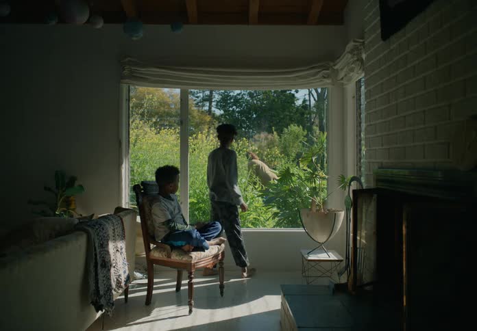 Children watch their mother in the garden outside