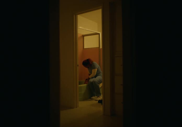 A woman is washing someone in the bathtub