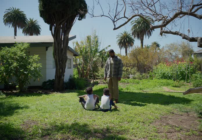 A father and his sons playing outdoors