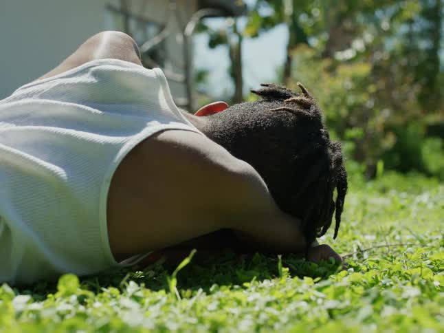 A view of a child resting on the lawn