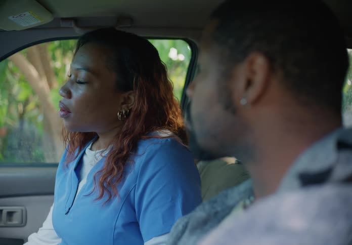 Mom gets into passenger side of car with dad who is in the drivers seat they have a conversation