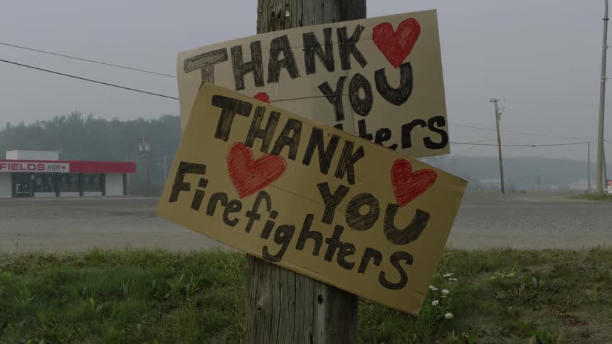 Signs are on the pole in front of the store