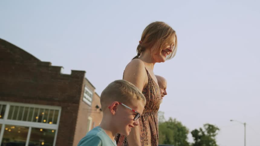 Two little boys walking and shopping with their grandparents in the late afternoon