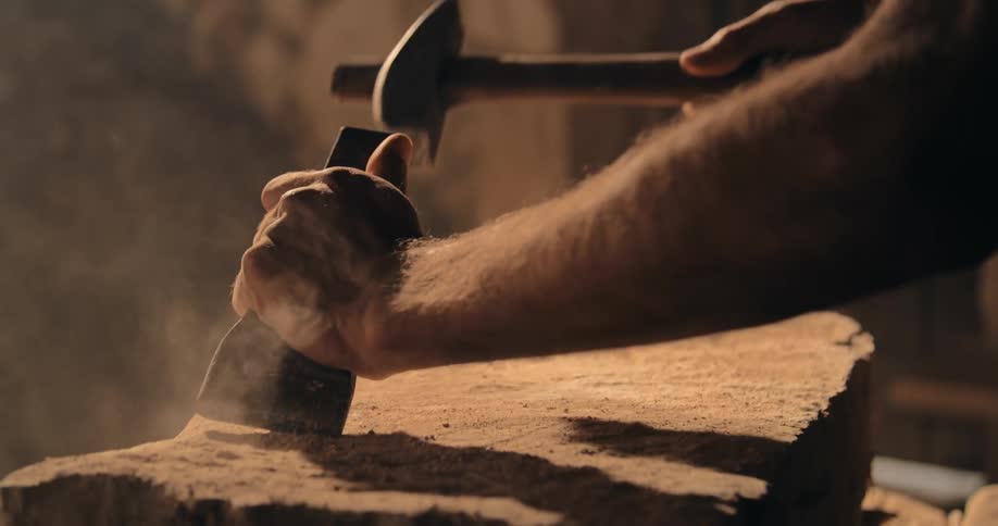 A man is carving stone