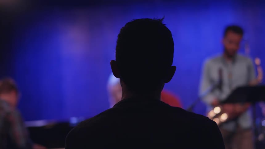 A person watches a musical show