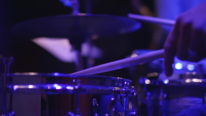 Close-up of a drummer tapping on his instruments