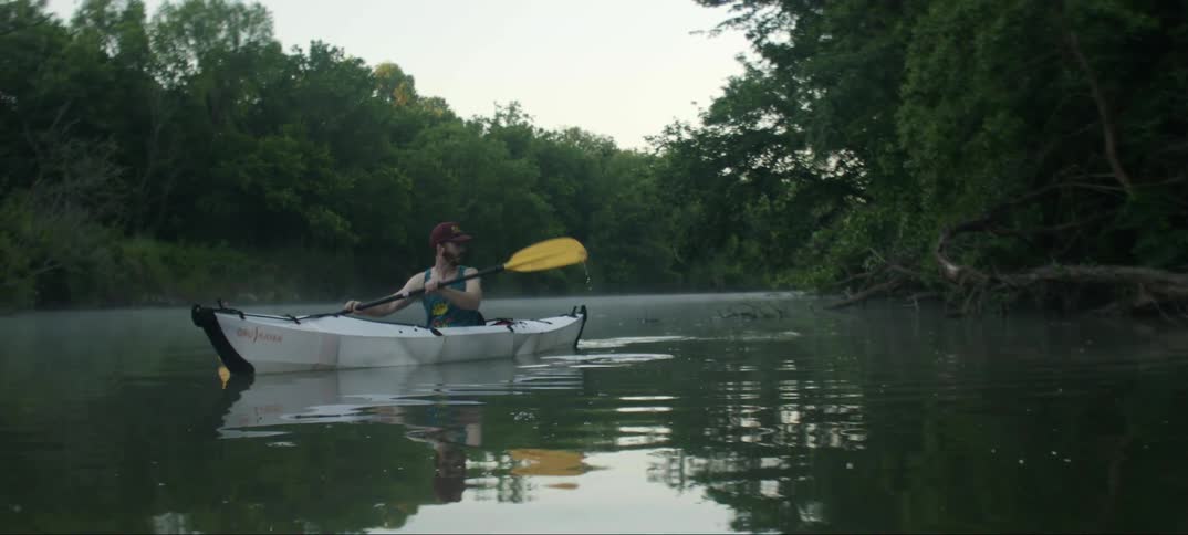 A man paddles a kayak