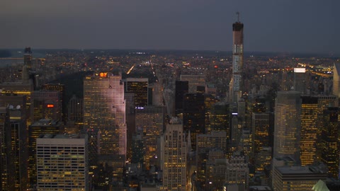 View of a large city with lights on in buildings at night