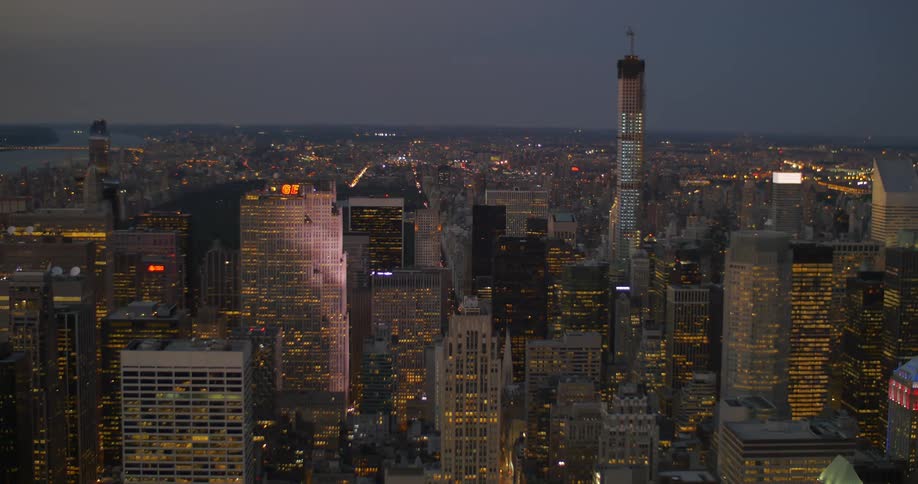 View of a large city with lights on in buildings at night