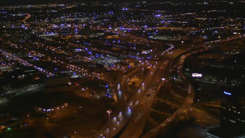 Vehicles drive on a busy city street