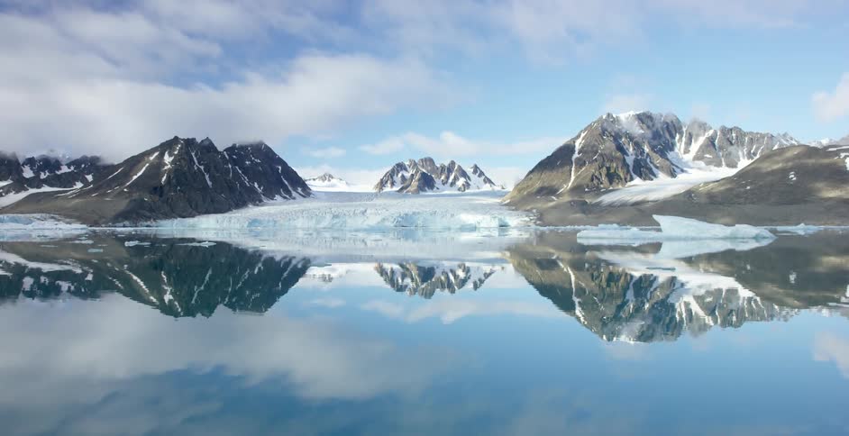 A mountain lake reflecting clouds during the winter