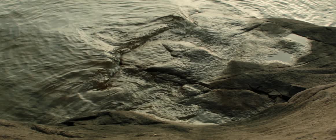 Water rolling over rocks at shoreline