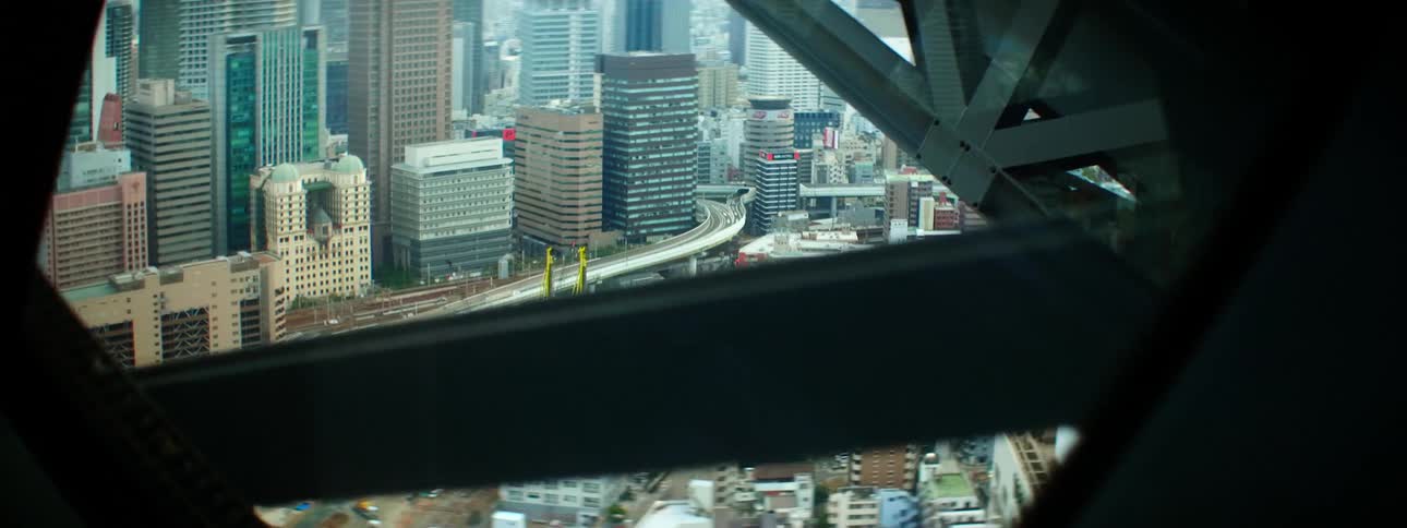 Downtown city skyscrapers and traffic shows between metal beams of structure