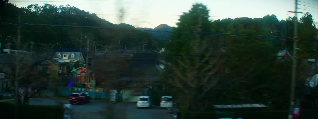 A small town area near trees and mountains