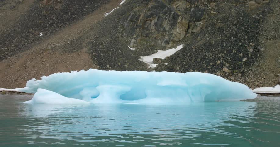 A large iceberg is near the shore